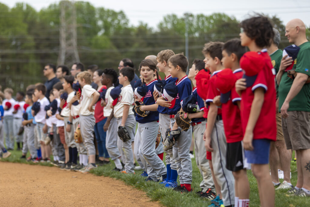 Pioneer Day with Pioneer Baseball League players standing in line for the National Anthem